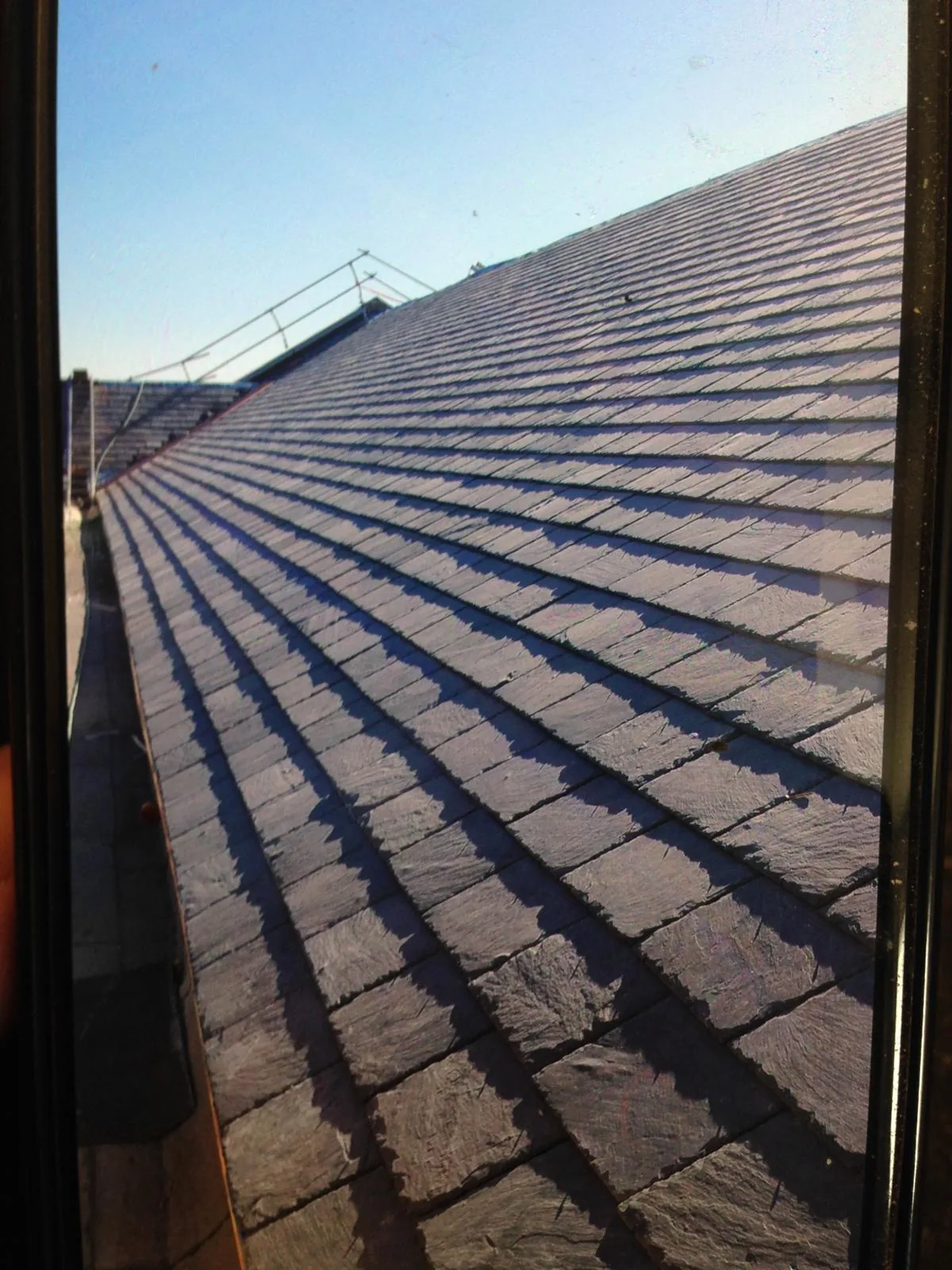 Completed slate roof photographed in clear winter sunshine